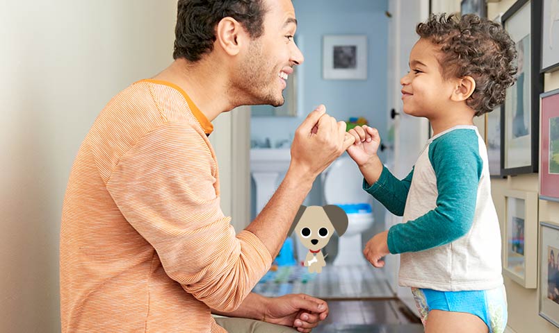 Dad congratulating boy in the bathroom after he uses the toilet